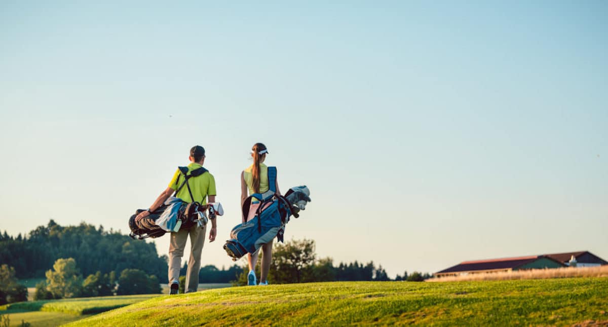 couple-walking-on-golf-course-1