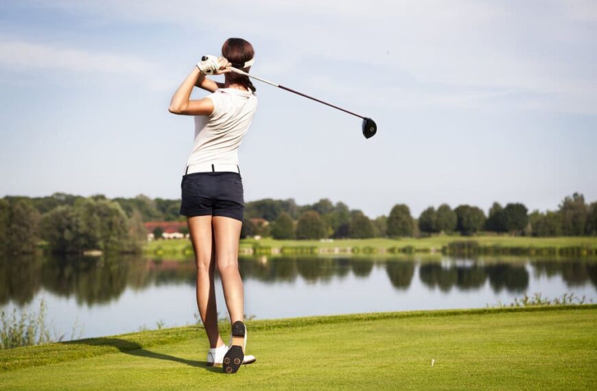 woman golfer tees off