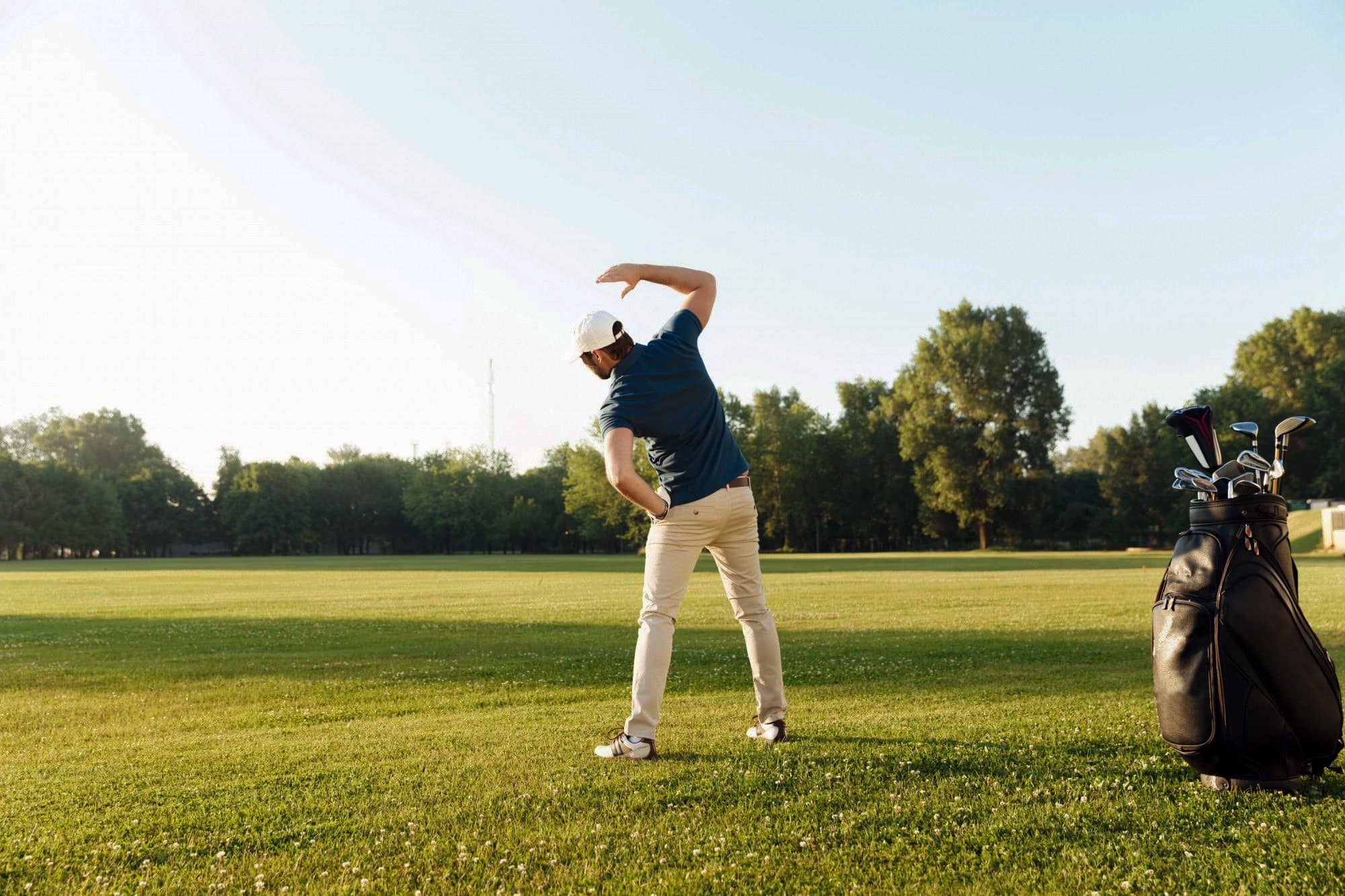 Young-male-golfer-stretching-muscles-before-starting-the-game