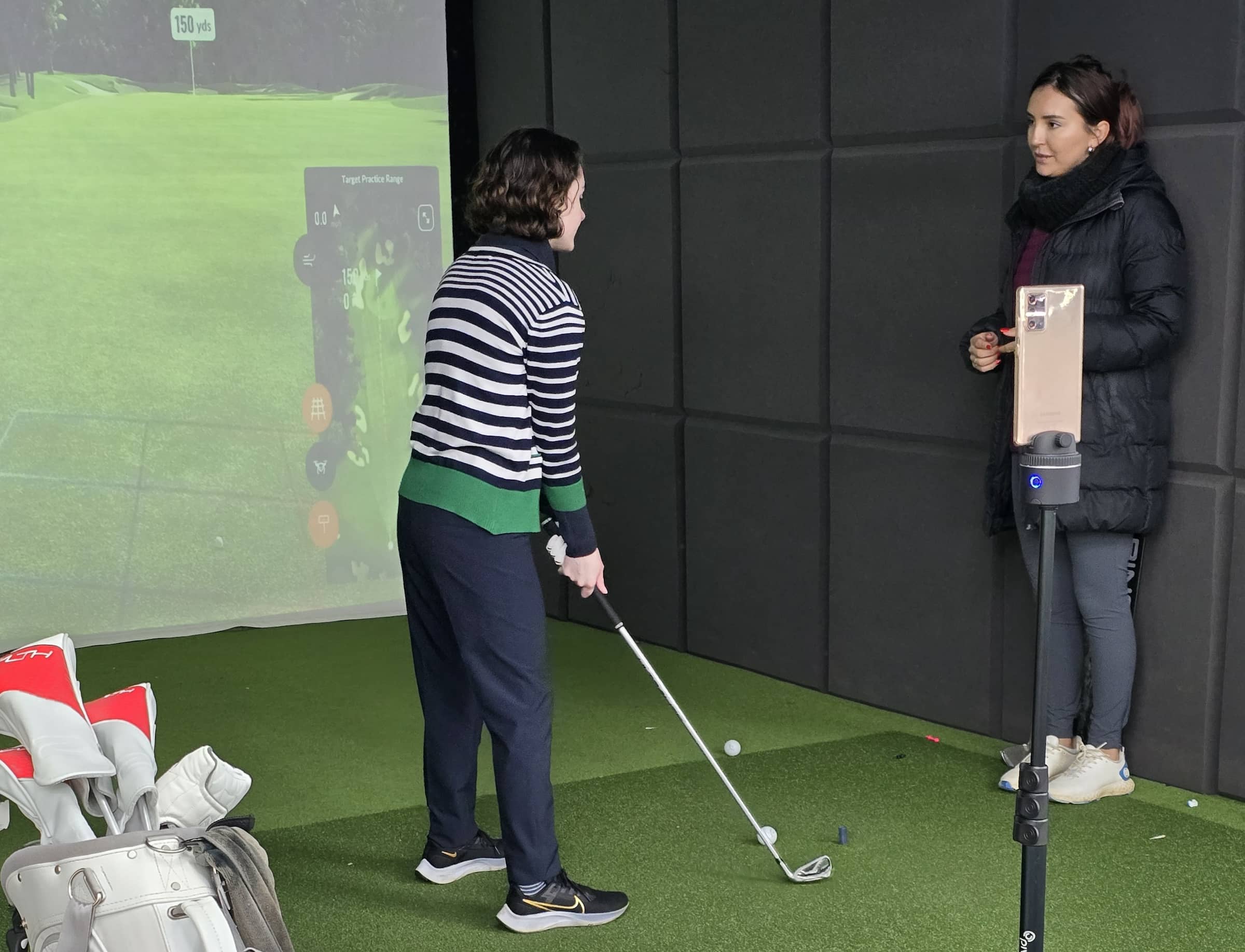 Golfer with trainer using PIVO tripod