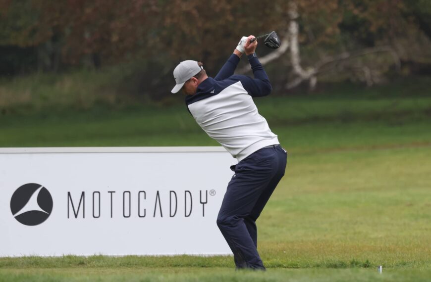 OJ Farrell strikes ball with Motocaddy sign in background