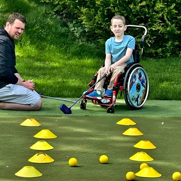 Young person putts from wheelchair