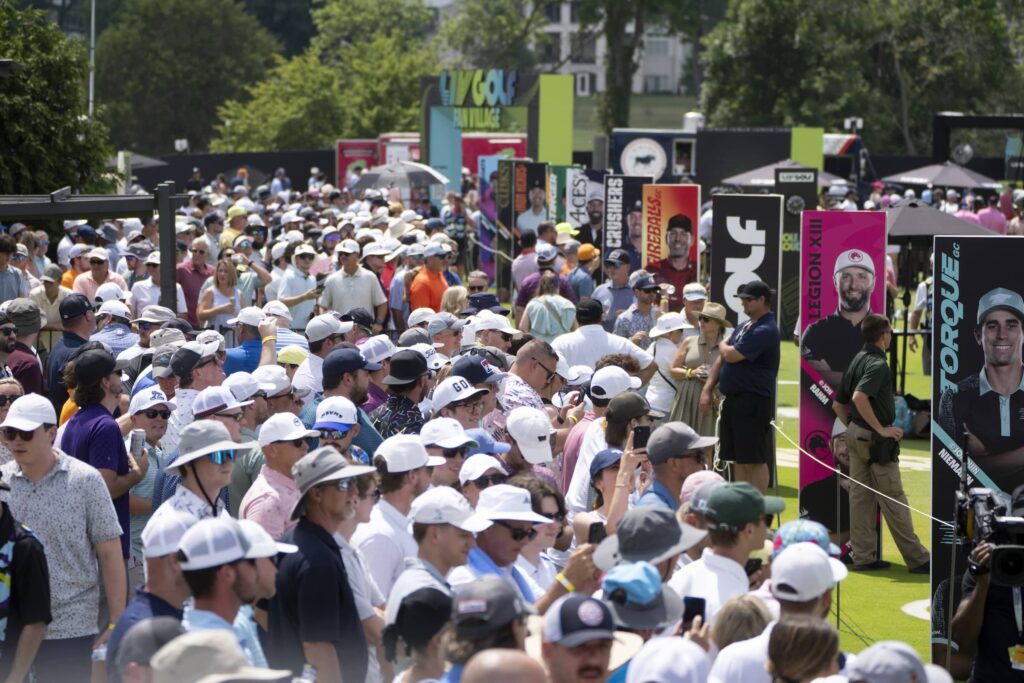 Fans watch play on the range before the second round of LIV Golf Nashville