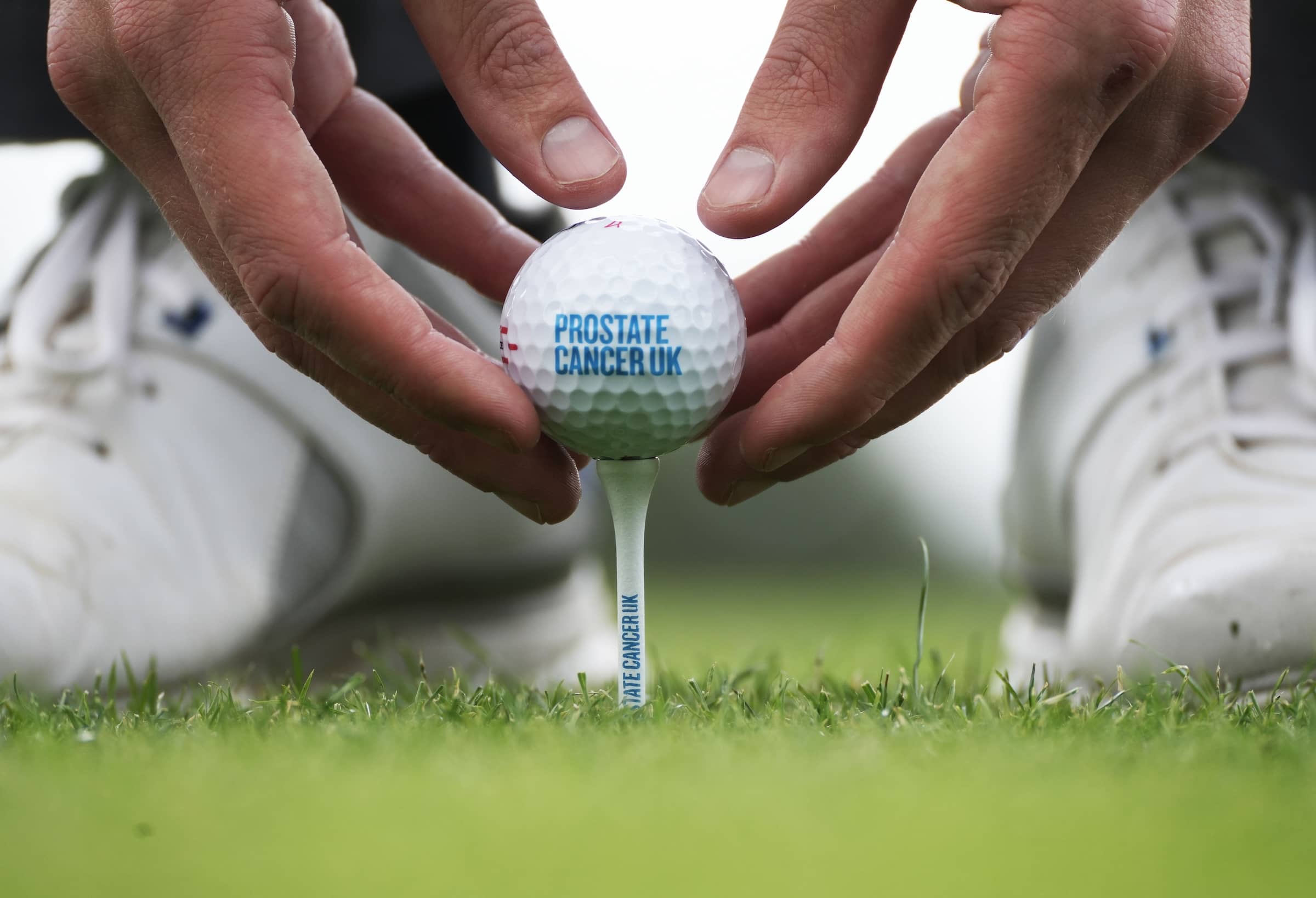 Golf Ball on Tee Prostate Cancer UK Logo