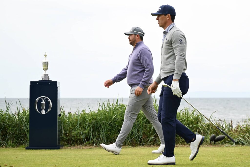 Billy Horschel and Thriston Lawrence walk past the Claret Jug on the first hole on day four of The 152nd Open championship at Royal Troon 