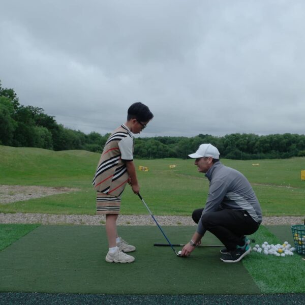 Young-Golfer-under-instruction-from-Golf-Teacher