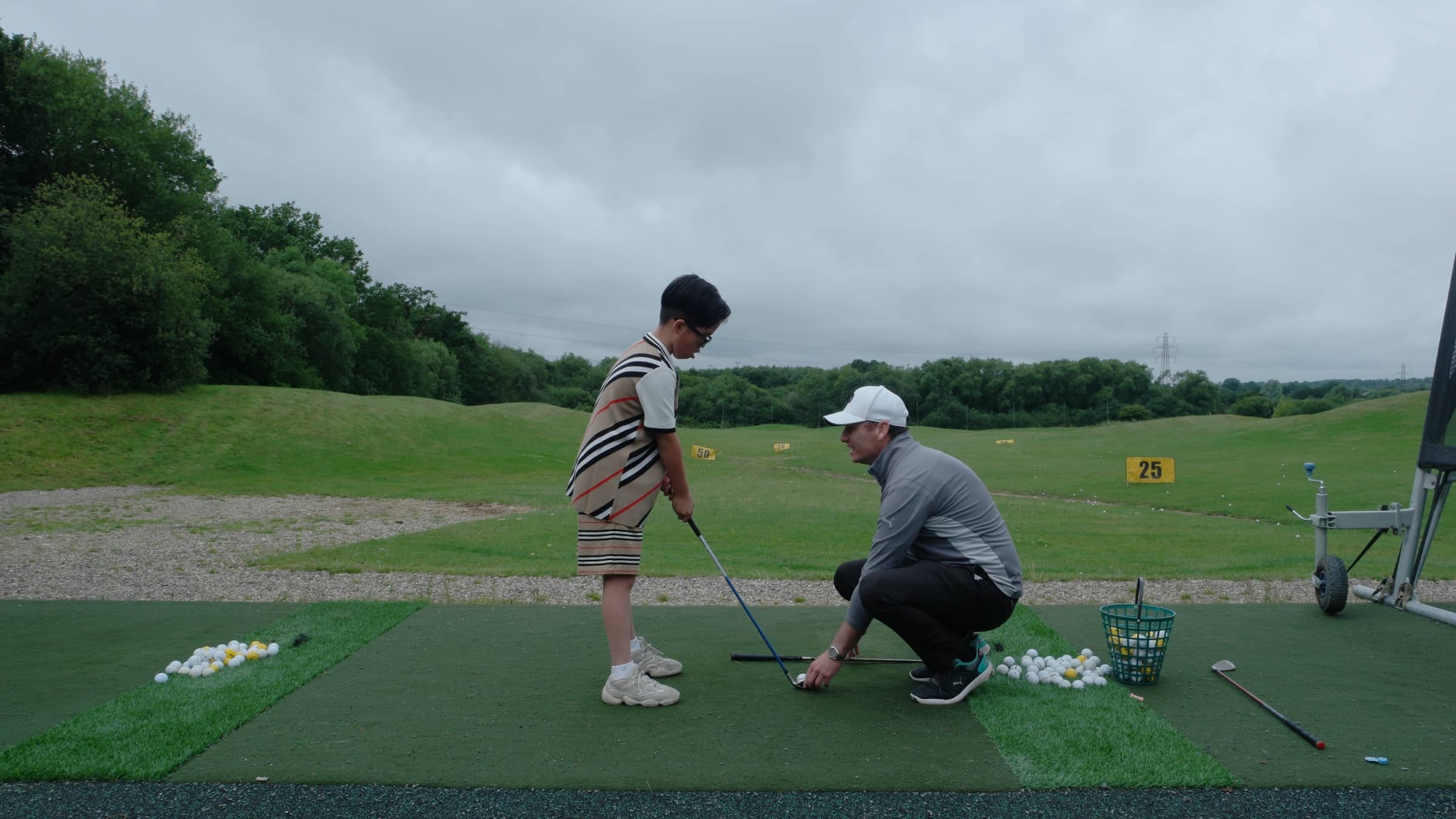 Young-Golfer-under-instruction-from-Golf-Teacher