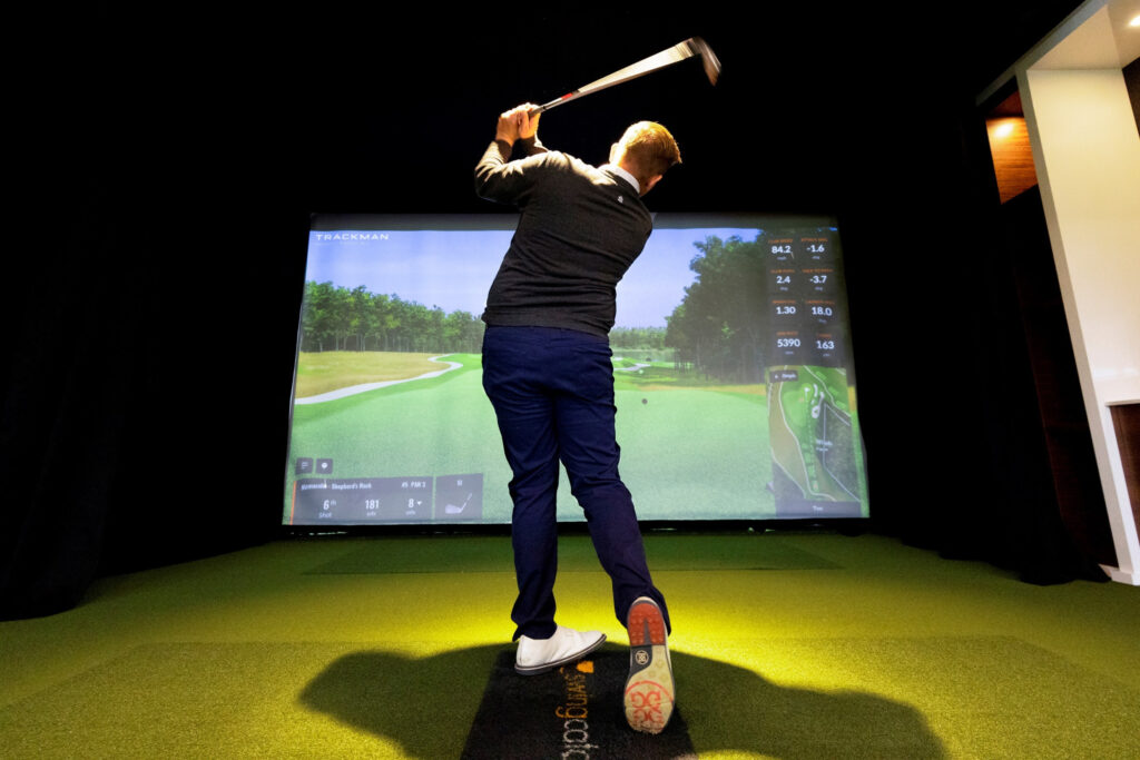 Golfer practicing on a simulator