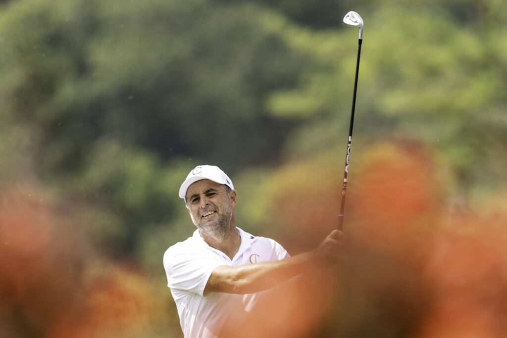 Richard Bland of Cleeks GC hits his shot from the 18th tee