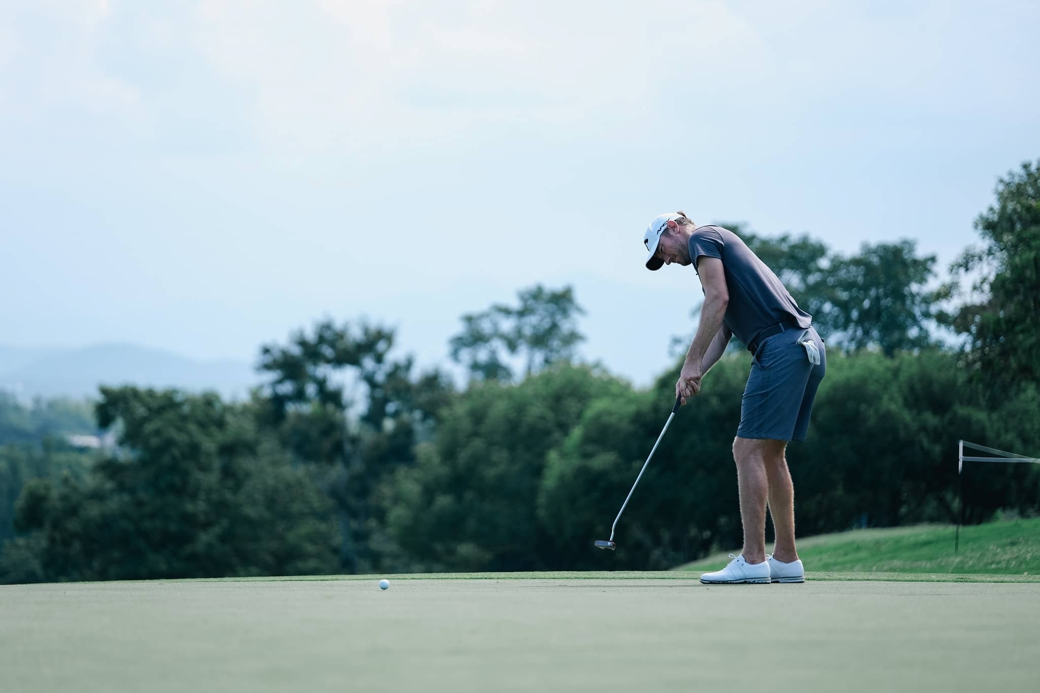 Chris Wood hits a putt during a pre-tournament practice round at the Black Mountain Championship in Hua Hin, Thailand