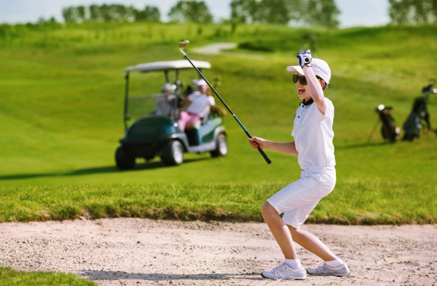 Youngster plays a bunker shot