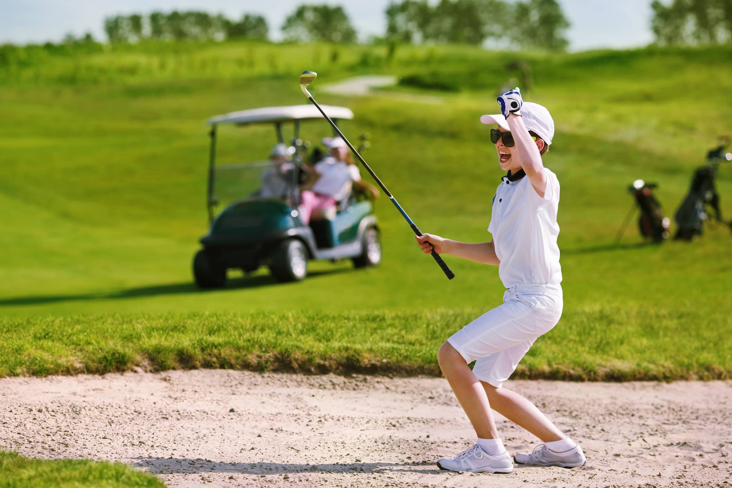 Youngster plays a bunker shot