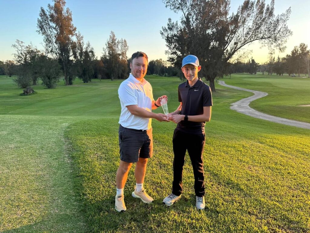 Harry being presented with his trophy by Graham Allchurch, Head of Brand & Campaigns at Your Golf Travel