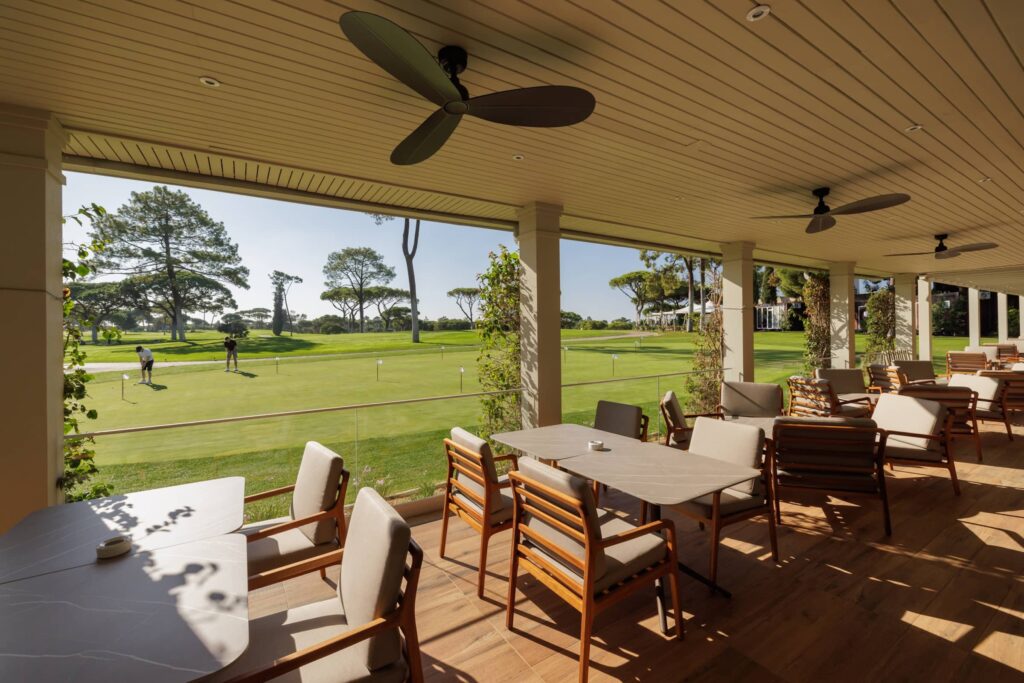 An exterior shot of the Old Course clubhouse with the practice green in the background