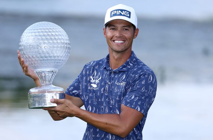 Johannes Veerman of the United States poses with the trophy on the 18th green following victory on day four of the Nedbank Golf Challenge