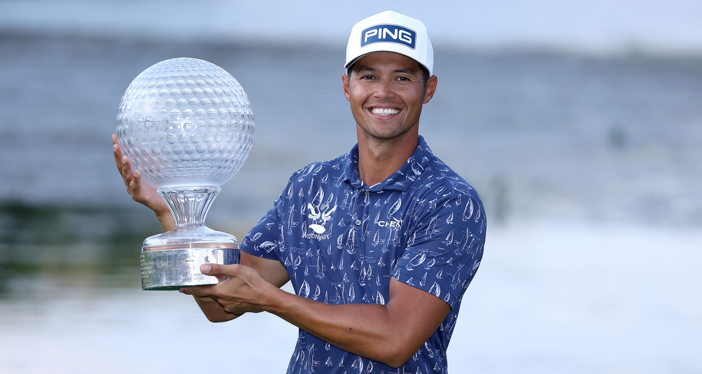 Johannes Veerman of the United States poses with the trophy on the 18th green following victory on day four of the Nedbank Golf Challenge