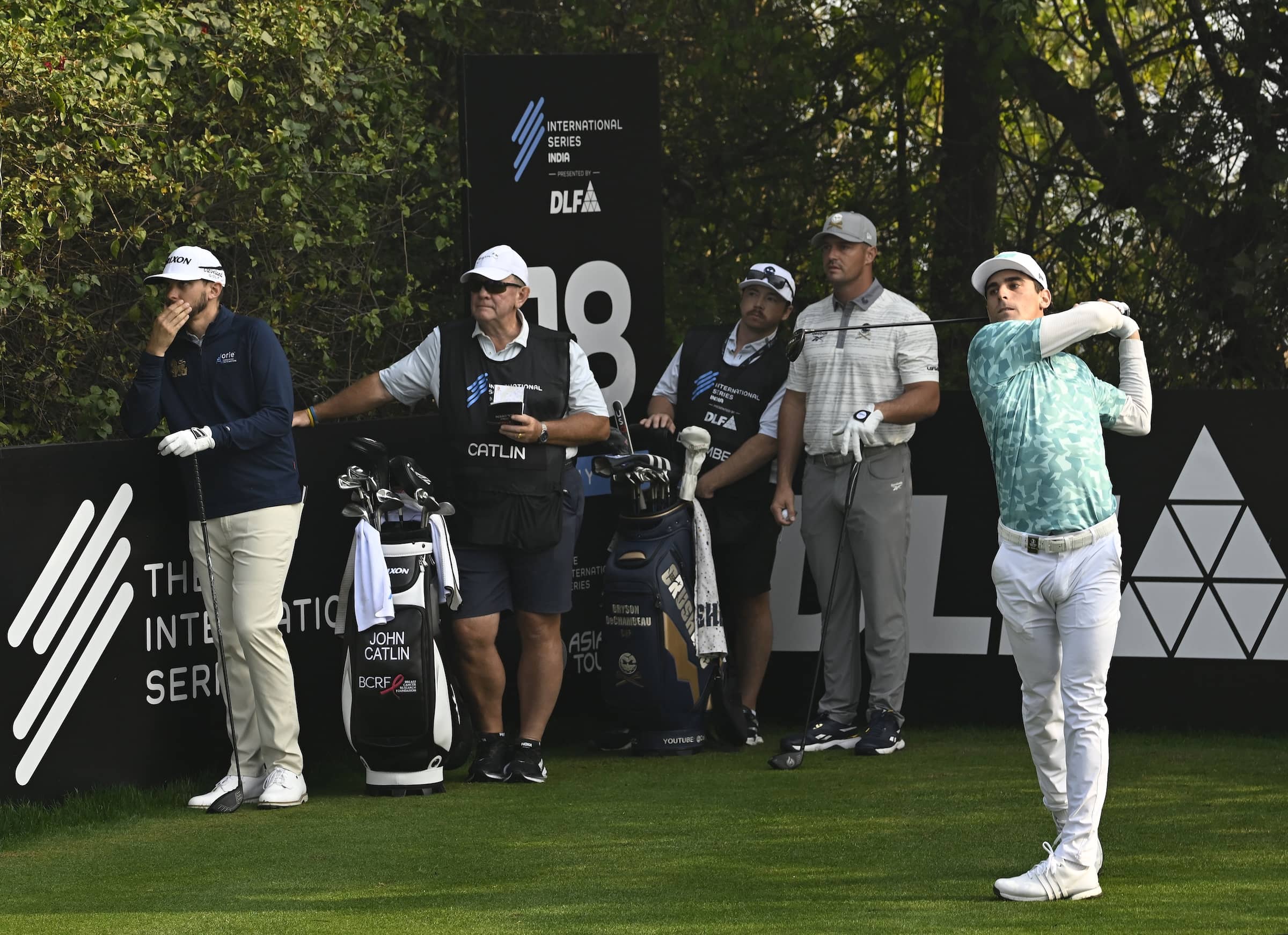 Joaquin Niemann pictured alongside Bryson DeChambeau and John Catlin on the 18th hole at DLF Golf and Country Club