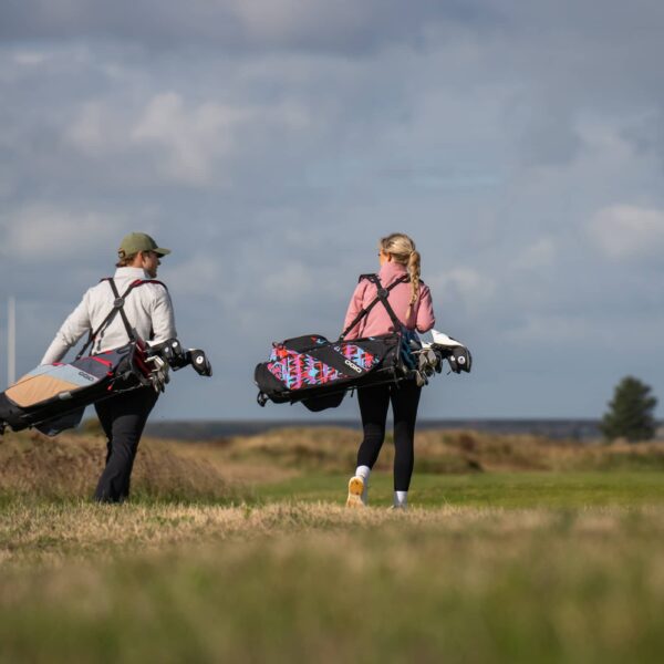 Golfer carries the ogio fuse stand bag