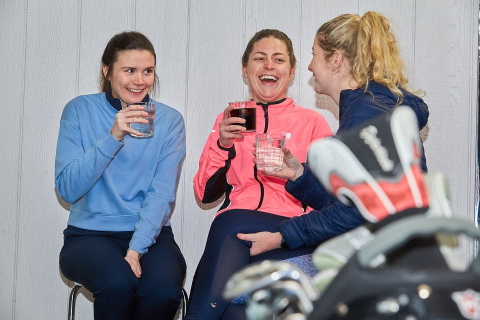 Female Golfers share a laugh over drinks