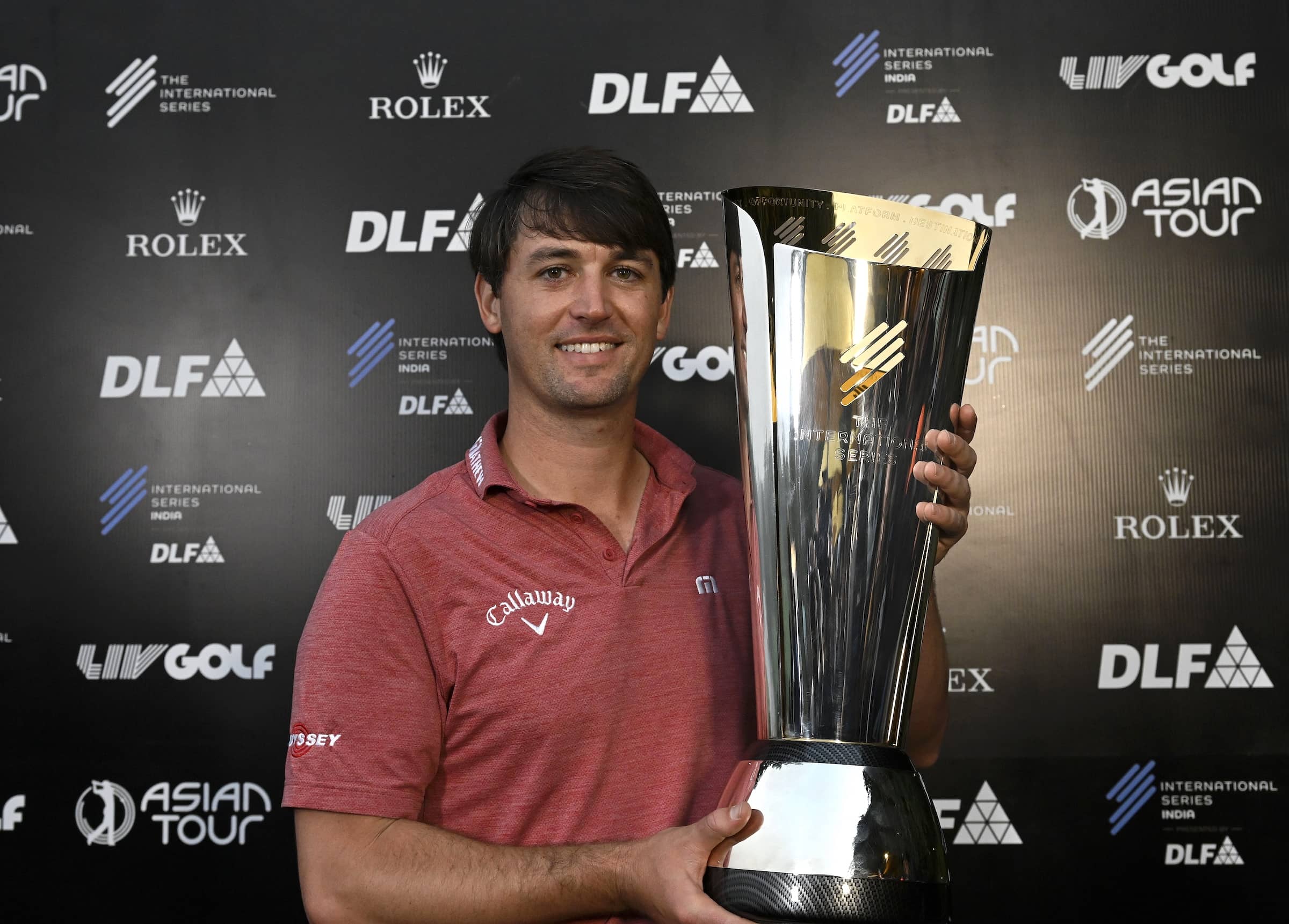 International Series India presented by DLF champion Ollie Schniederjans pictured with The International Series trophy after securing victory at DLF Golf and Country Club. The tournament was the first of 10 on The International Series in 2025.