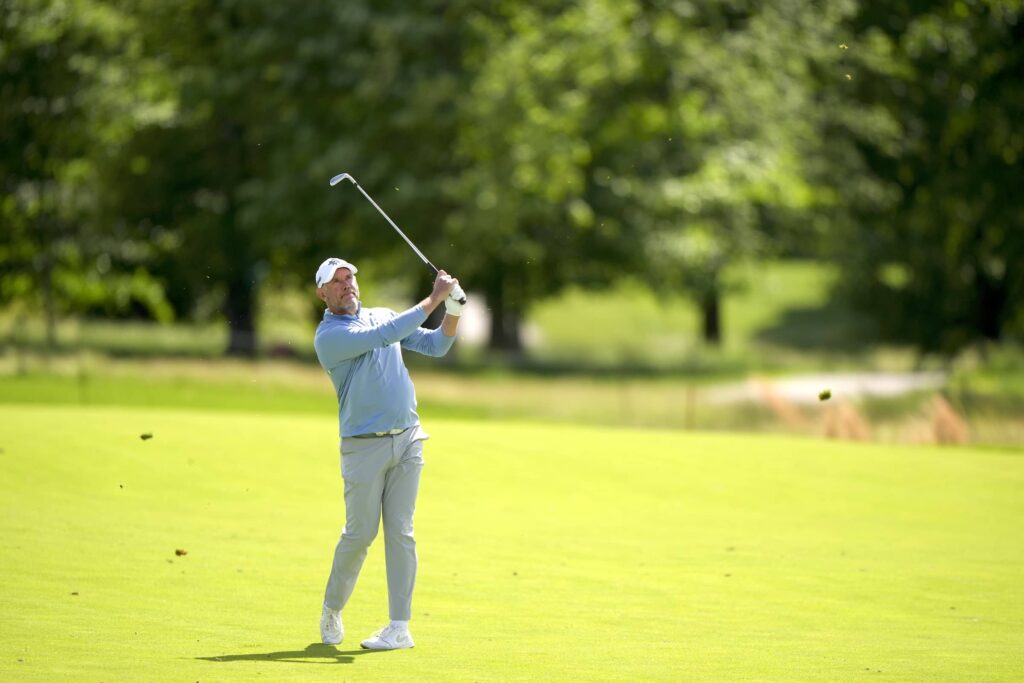 Lee Westwood hits his second shot on the 18th hole during the third round of the Senior PGA Championship at Congressional Country Club