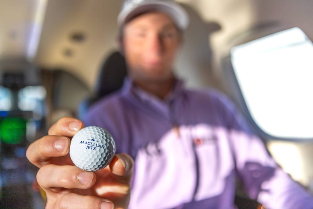 Magellan Jets Passenger holding Golf Ball