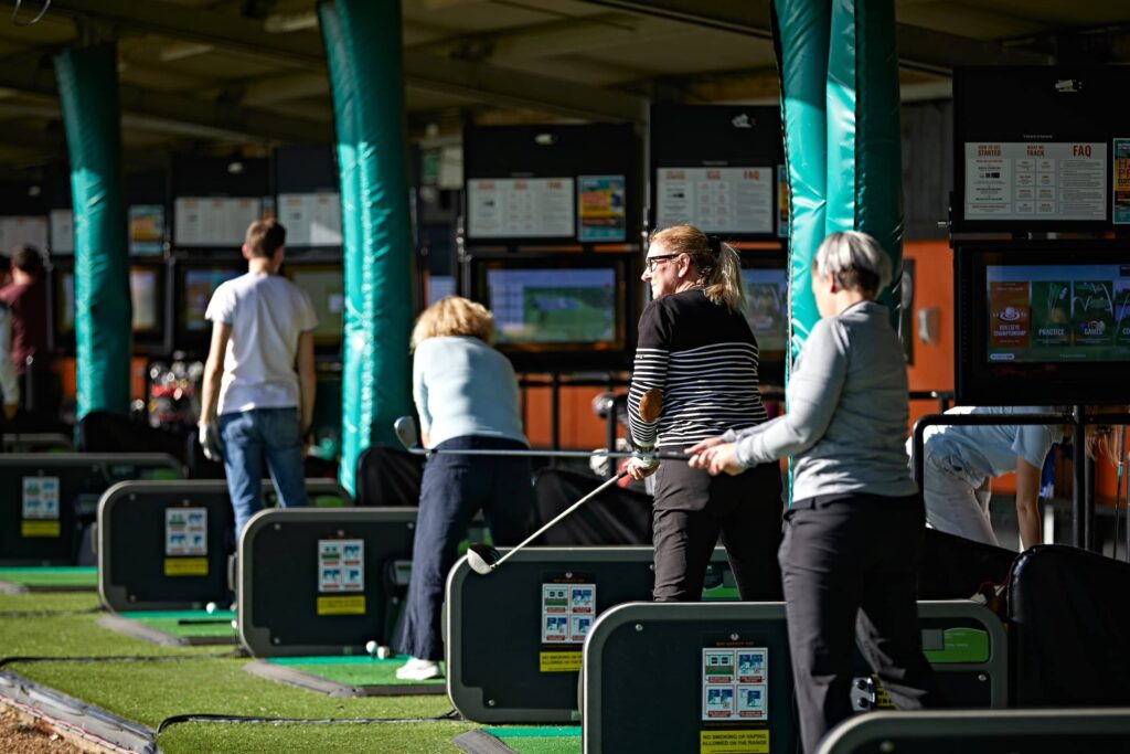 People on golf driving range